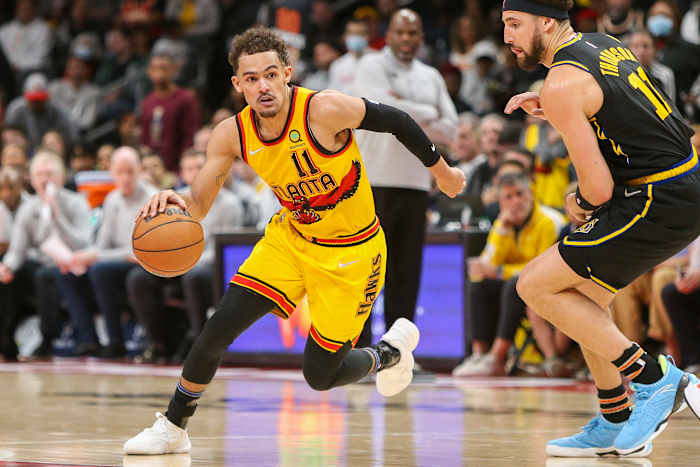 Hawks guard Trae Young dribbles past Warriors guard Klay Thompson.